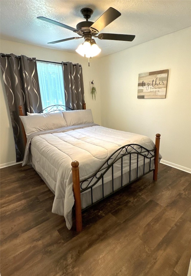 bedroom featuring a textured ceiling, dark hardwood / wood-style flooring, and ceiling fan