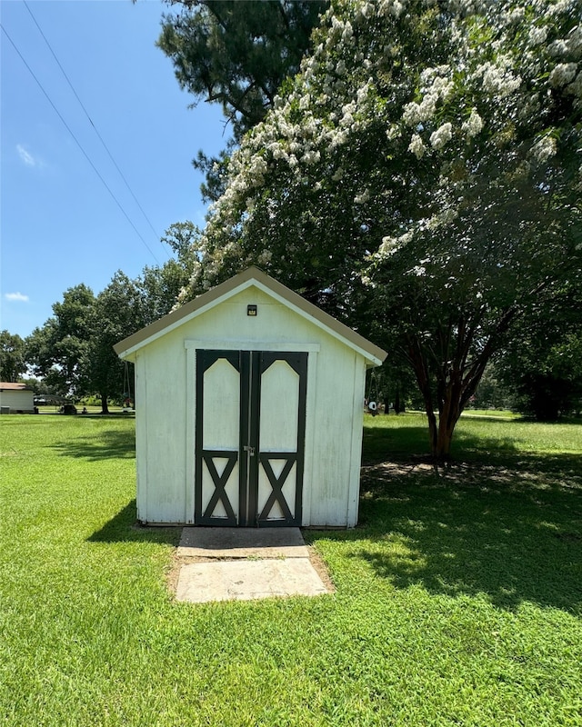 view of outbuilding featuring a yard