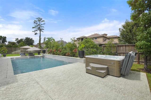 view of pool featuring a hot tub and a patio area