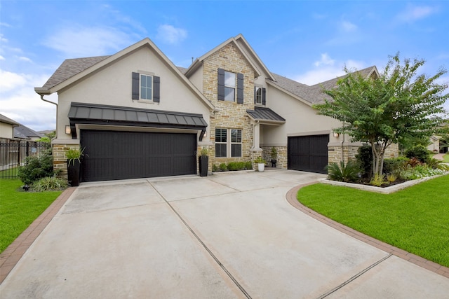 view of front of home featuring a front yard and a garage