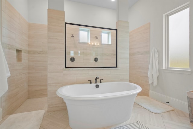 bathroom featuring independent shower and bath, tile patterned flooring, and plenty of natural light