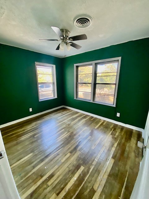 unfurnished room with hardwood / wood-style flooring and ceiling fan