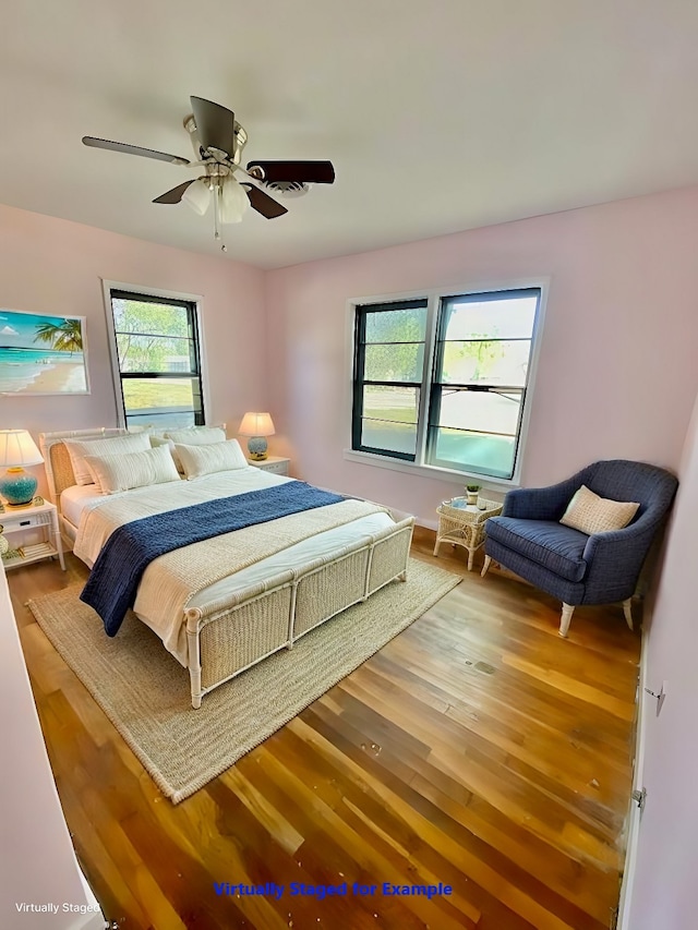 bedroom with hardwood / wood-style floors and ceiling fan