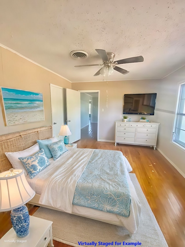 bedroom featuring hardwood / wood-style floors and ceiling fan