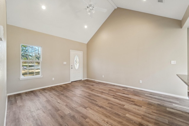 interior space featuring hardwood / wood-style flooring, ceiling fan, and high vaulted ceiling