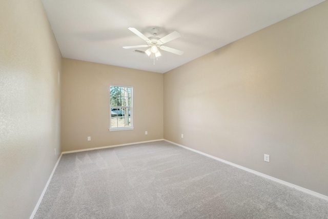 spare room featuring light carpet and ceiling fan