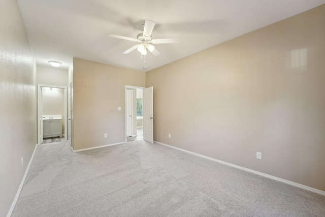 carpeted spare room with ceiling fan