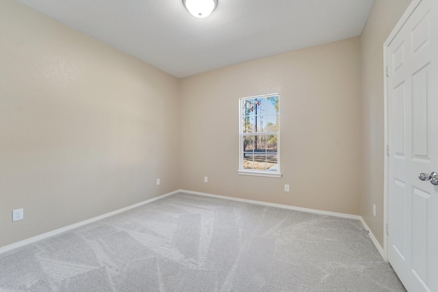 spare room featuring light colored carpet