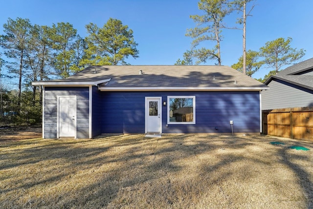 back of property featuring a lawn