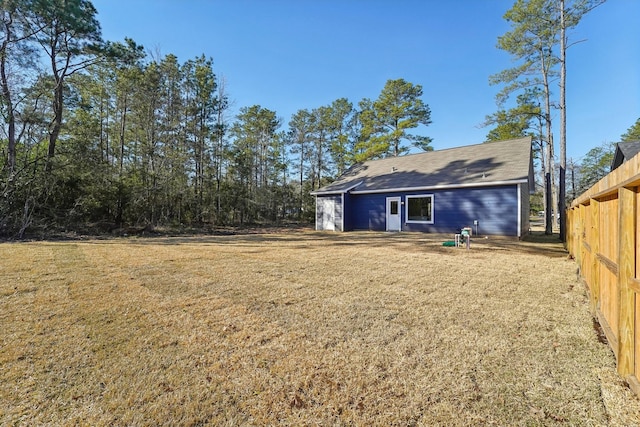 rear view of house featuring a lawn