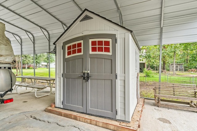 view of outdoor structure featuring a lawn and a carport