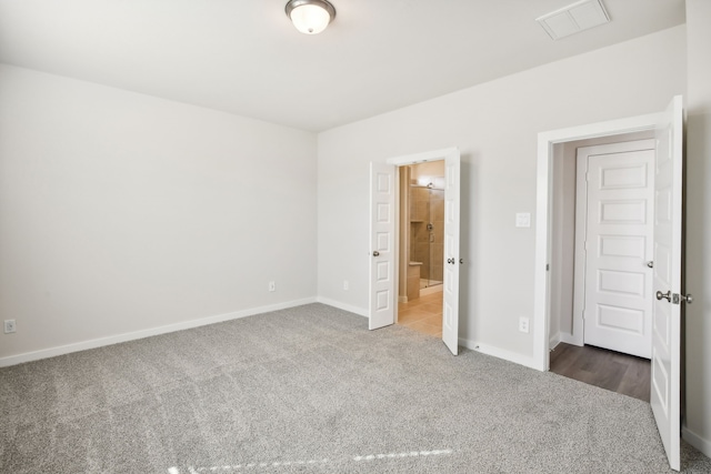 unfurnished bedroom with dark carpet