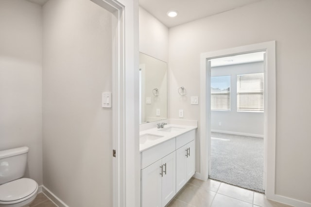 bathroom with tile patterned floors, vanity, and toilet