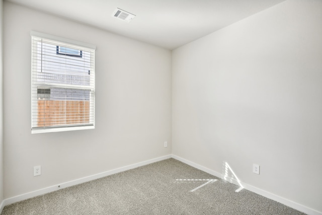 empty room with plenty of natural light and carpet