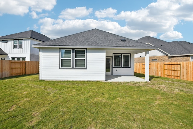 rear view of property featuring a patio area and a yard