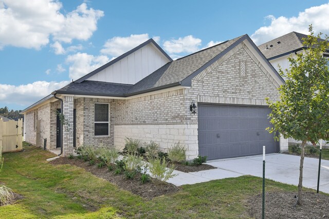 view of front of property with a garage and a front yard