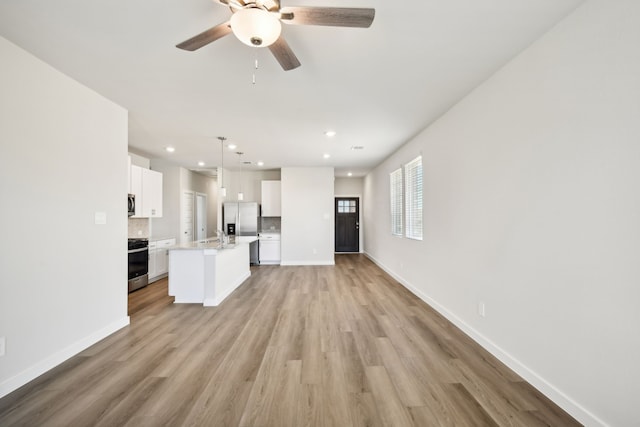 unfurnished living room with light hardwood / wood-style floors and ceiling fan