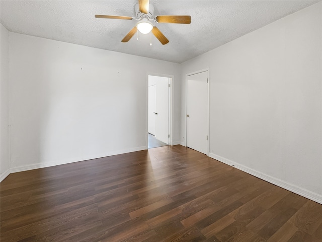 unfurnished room featuring dark wood-type flooring, ceiling fan, and a textured ceiling