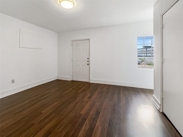 spare room with dark hardwood / wood-style flooring