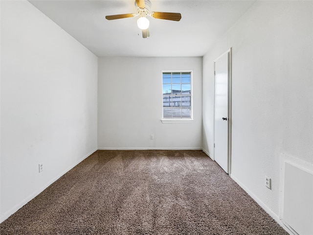 spare room featuring carpet and ceiling fan