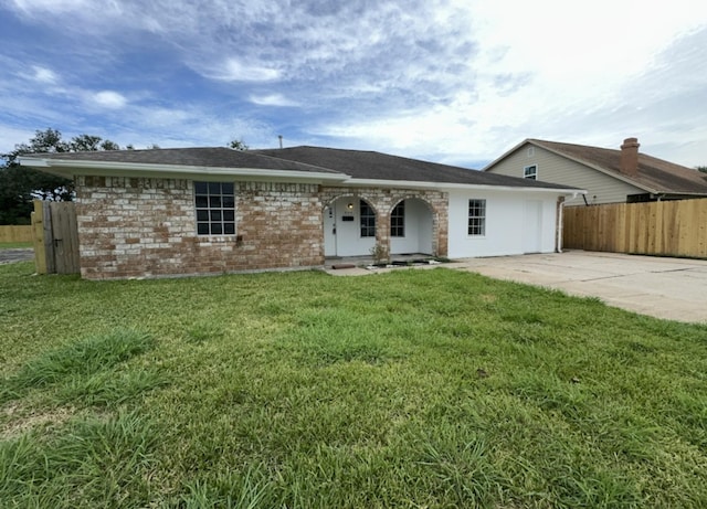 single story home featuring a front yard, fence, brick siding, and driveway