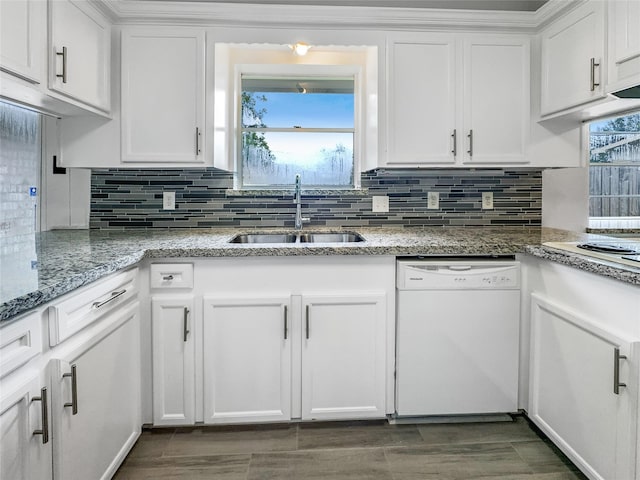 kitchen with white cabinets, white appliances, and a sink