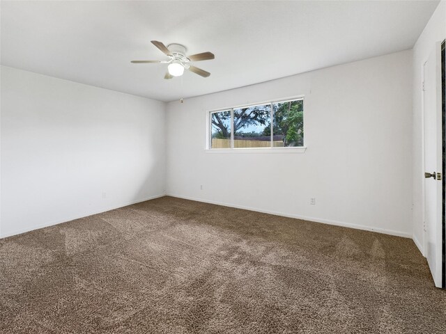 unfurnished room with ceiling fan and carpet floors