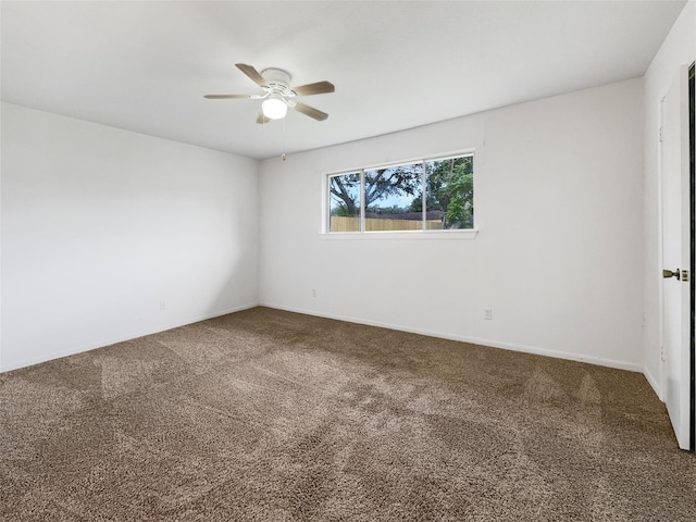 carpeted empty room with a ceiling fan