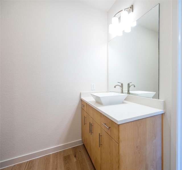 bathroom with hardwood / wood-style flooring and vanity