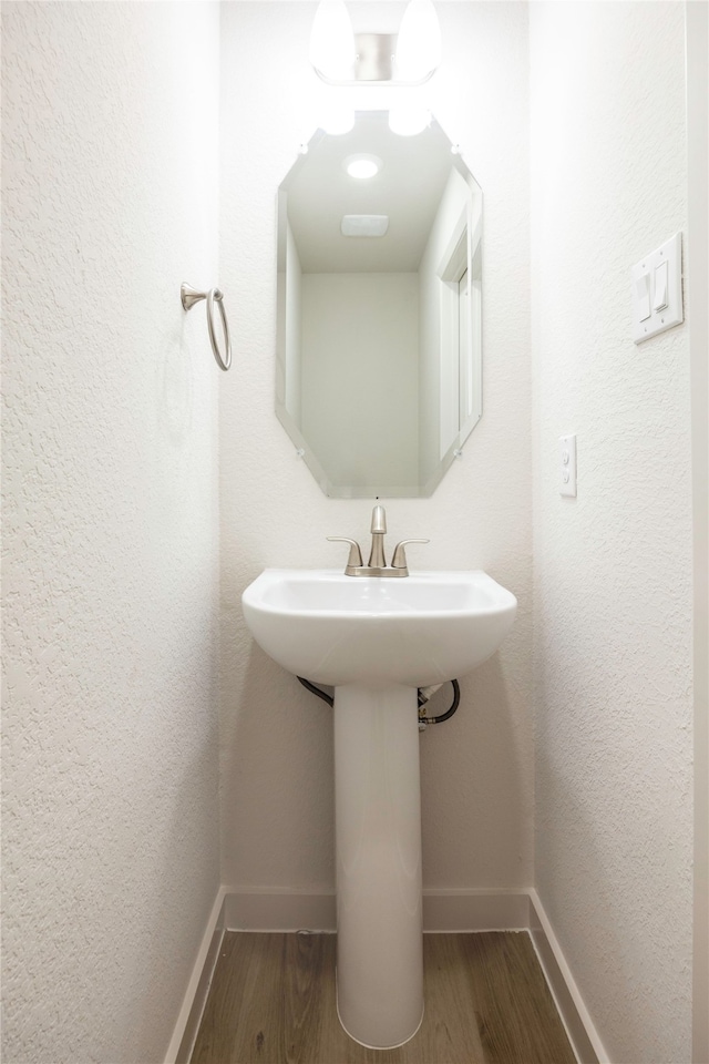 bathroom featuring sink and hardwood / wood-style floors