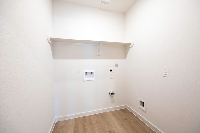 clothes washing area with light hardwood / wood-style flooring, hookup for an electric dryer, hookup for a gas dryer, and washer hookup