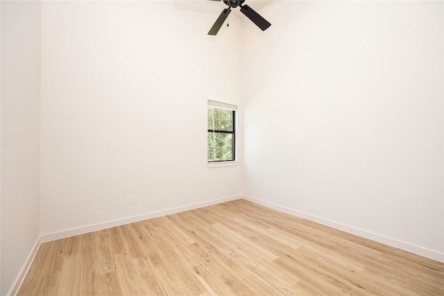 empty room with ceiling fan and light hardwood / wood-style floors