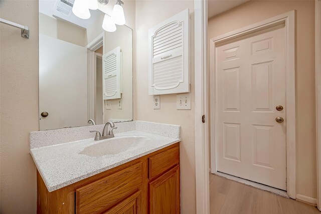 bathroom with vanity and wood-type flooring