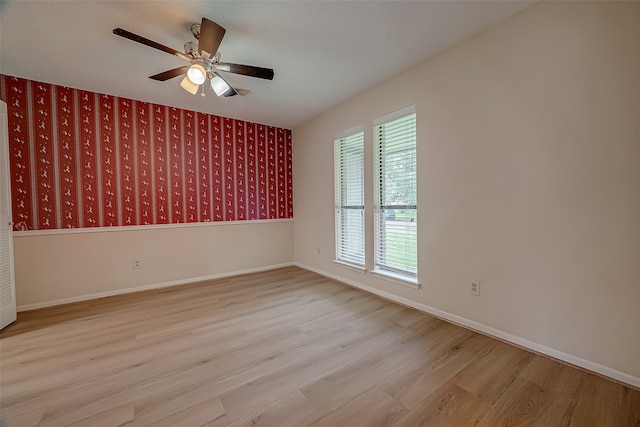 empty room featuring light wood-type flooring and ceiling fan