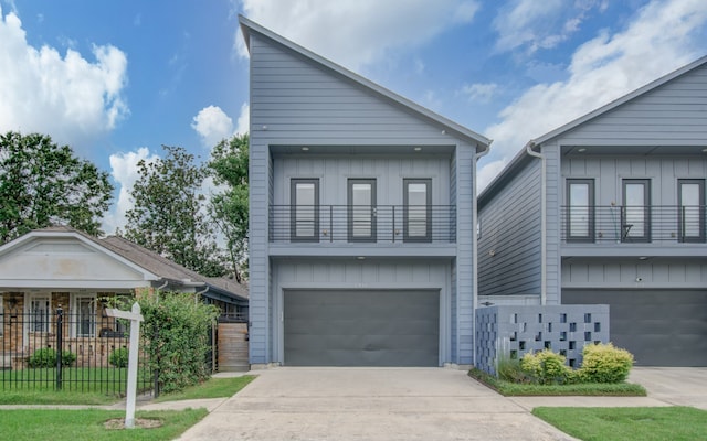 view of front of home with a balcony and a garage