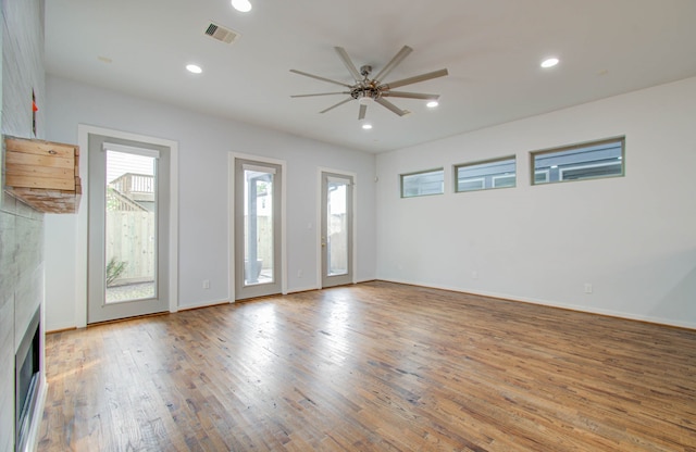 interior space featuring ceiling fan, hardwood / wood-style flooring, and a healthy amount of sunlight