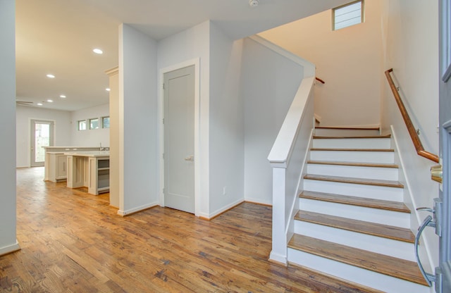 staircase with wood-type flooring