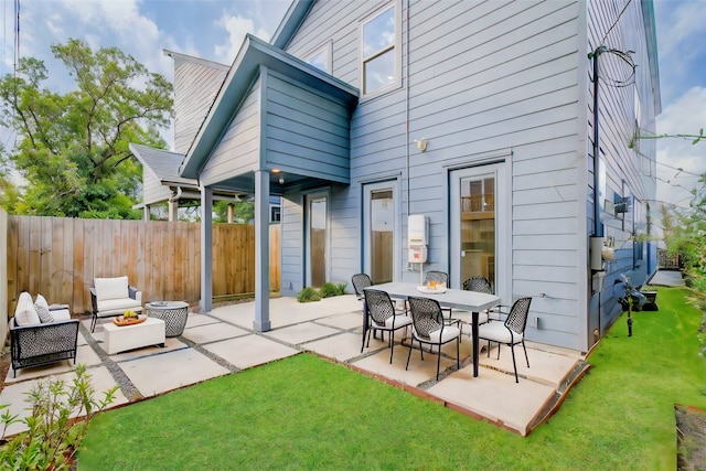 back of house with a patio and a yard