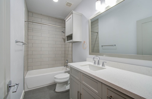 full bathroom with vanity, tiled shower / bath combo, toilet, and tile patterned floors