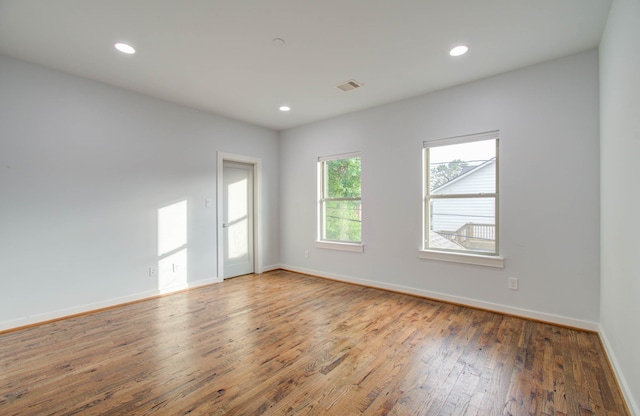 unfurnished room featuring hardwood / wood-style flooring