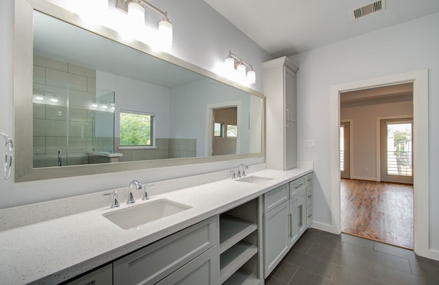 bathroom featuring wood-type flooring, vanity, and a shower with shower door