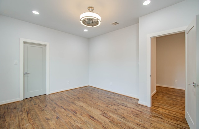 unfurnished room with wood-type flooring