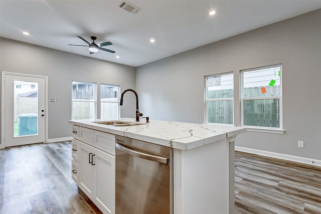 kitchen featuring dishwasher, plenty of natural light, an island with sink, and sink