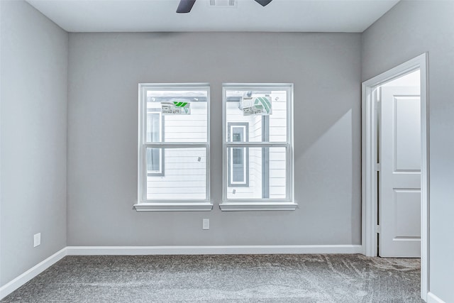 carpeted spare room with ceiling fan