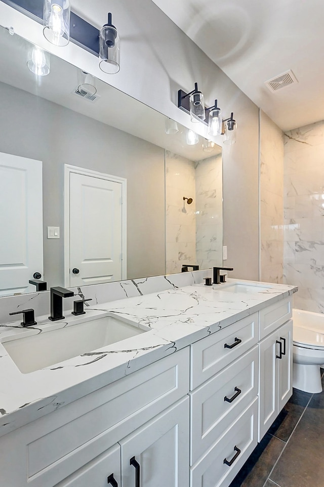 full bathroom with vanity, toilet, tiled shower / bath combo, and tile patterned floors