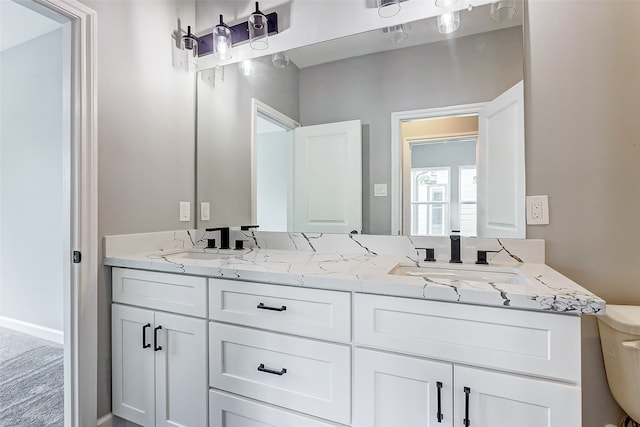 bathroom featuring vanity and toilet