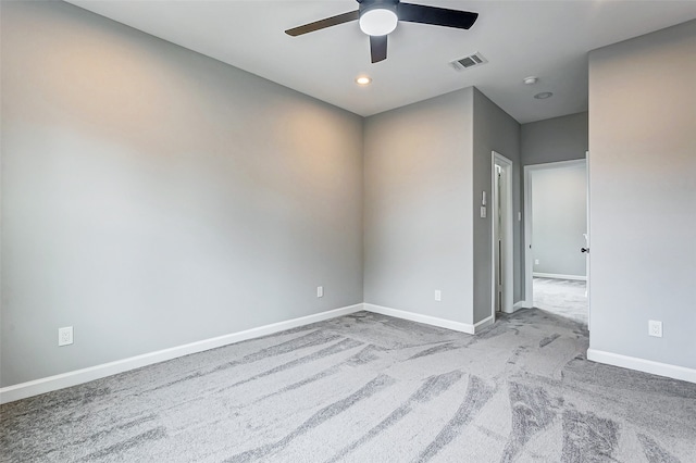 unfurnished room with ceiling fan and light carpet