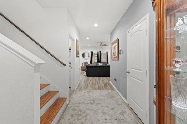 carpeted foyer entrance featuring ceiling fan