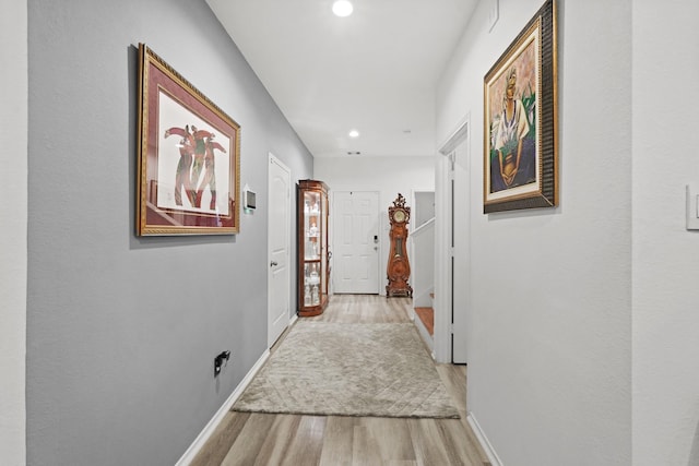 hallway with recessed lighting, baseboards, and wood finished floors