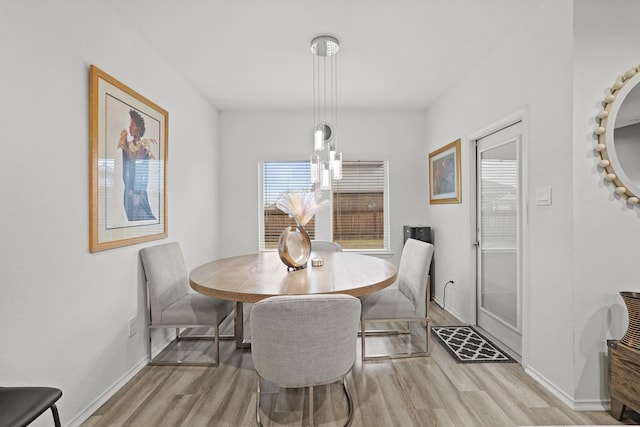 dining room with light wood-style floors and baseboards